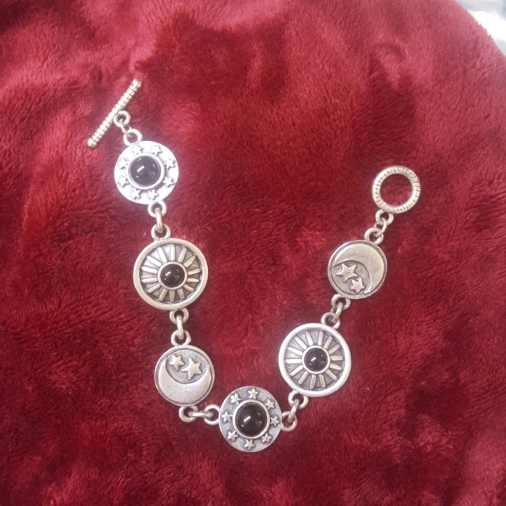 Silver tone with black faux onyx moon and star bra